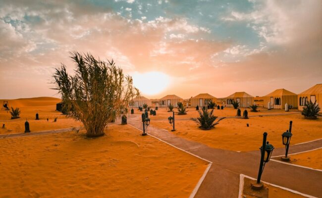 Desert camp at sunset with tents and tents